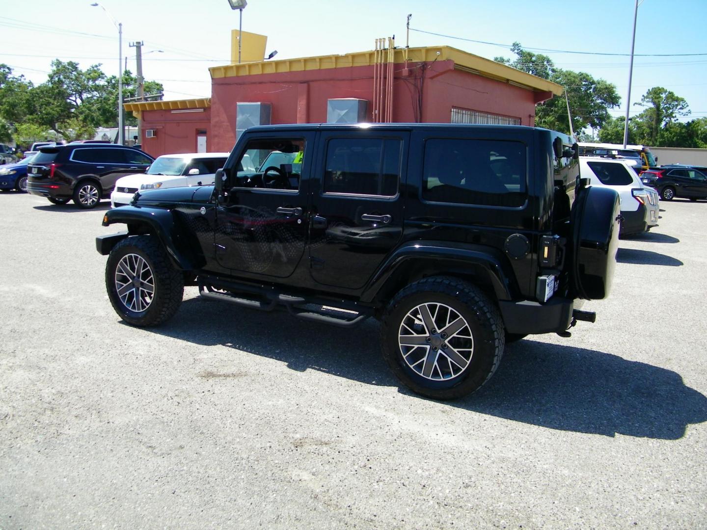 2014 Black /Black Jeep Wrangler Unlimited Sahara 4WD (1C4BJWEG2EL) with an 3.6L V6 DOHC 24V FFV engine, Automatic transmission, located at 4000 Bee Ridge Road, Sarasota, FL, 34233, (941) 926-0300, 27.298664, -82.489151 - Photo#3