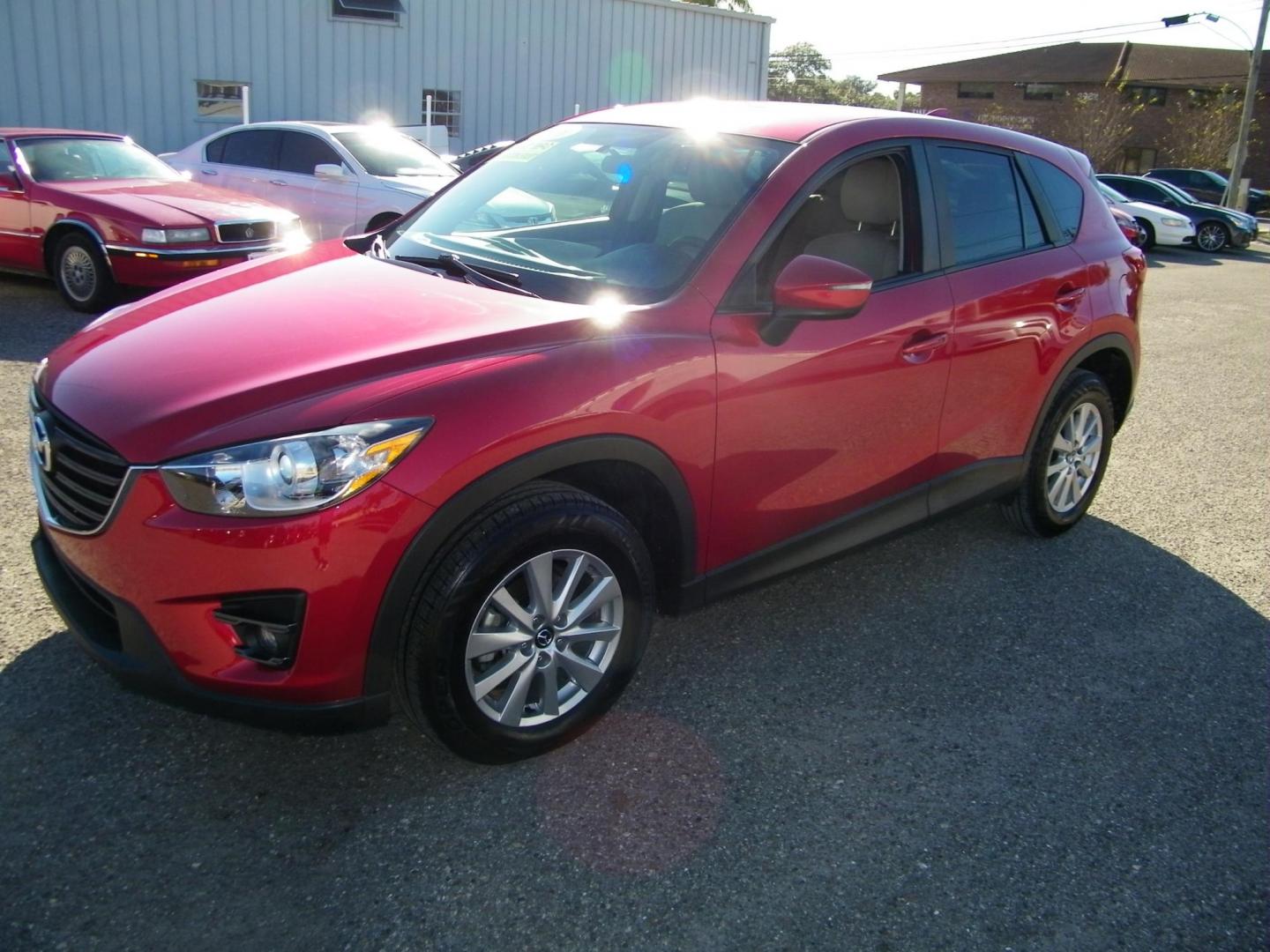 2016 Red /Beige Mazda CX-5 Touring (JM3KE2CY0G0) with an 2.5L L4 DOHC 16V engine, 6-Speed Automatic transmission, located at 4000 Bee Ridge Road, Sarasota, FL, 34233, (941) 926-0300, 27.298664, -82.489151 - Photo#0