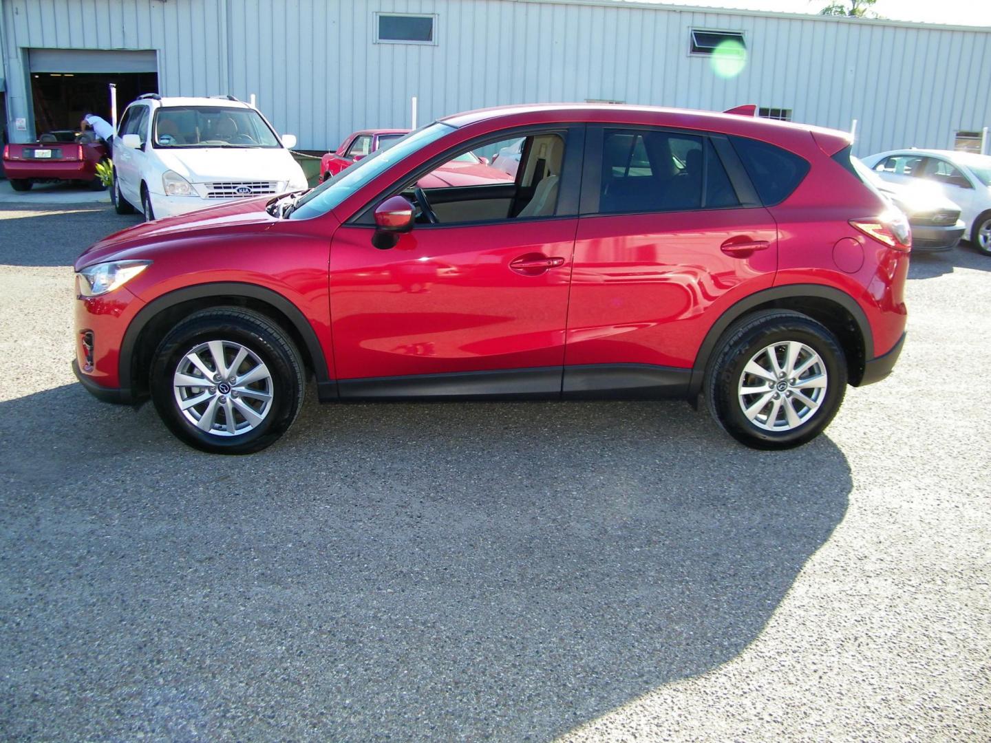 2016 Red /Beige Mazda CX-5 Touring (JM3KE2CY0G0) with an 2.5L L4 DOHC 16V engine, 6-Speed Automatic transmission, located at 4000 Bee Ridge Road, Sarasota, FL, 34233, (941) 926-0300, 27.298664, -82.489151 - Photo#2