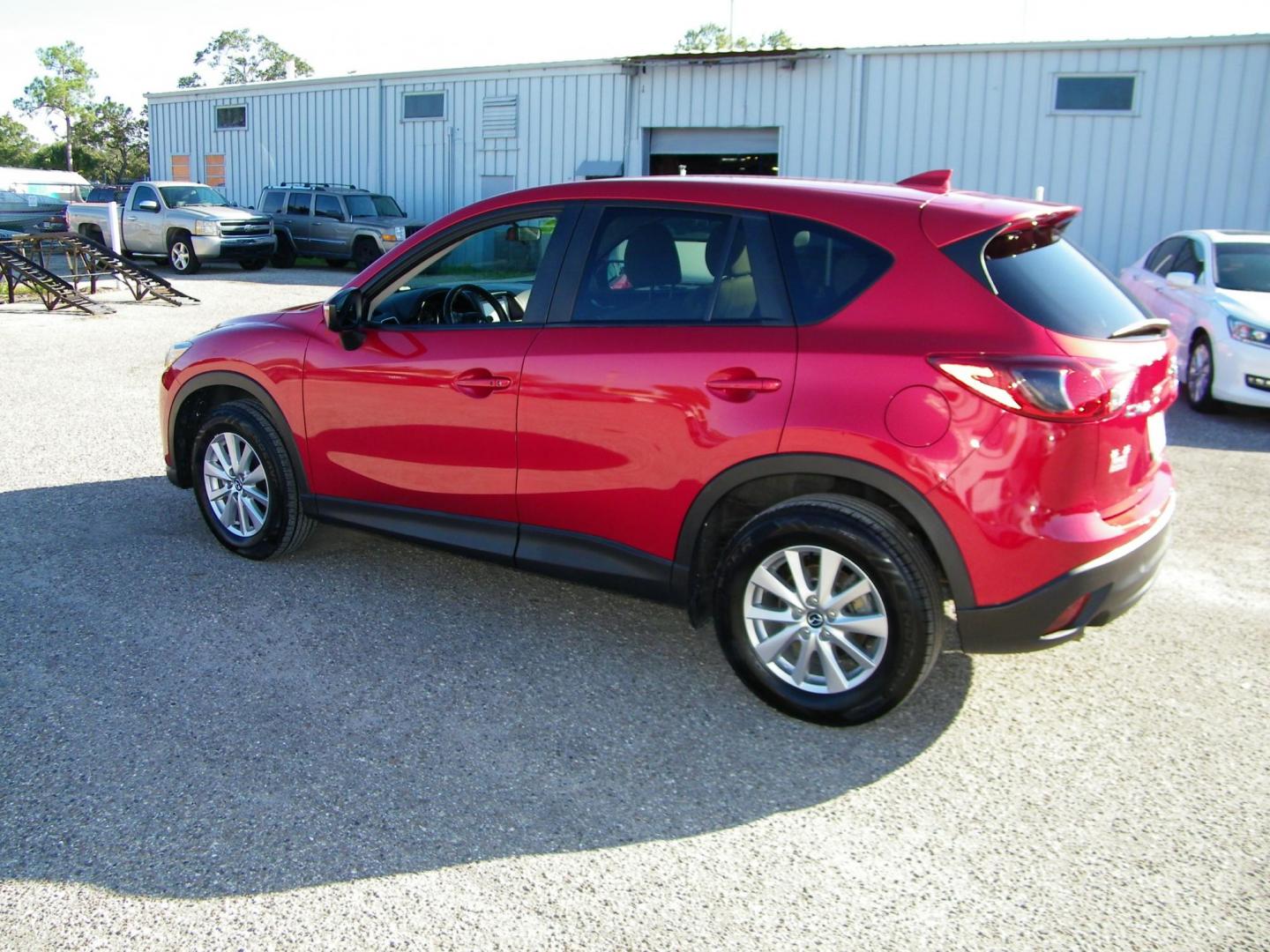 2016 Red /Beige Mazda CX-5 Touring (JM3KE2CY0G0) with an 2.5L L4 DOHC 16V engine, 6-Speed Automatic transmission, located at 4000 Bee Ridge Road, Sarasota, FL, 34233, (941) 926-0300, 27.298664, -82.489151 - Photo#3
