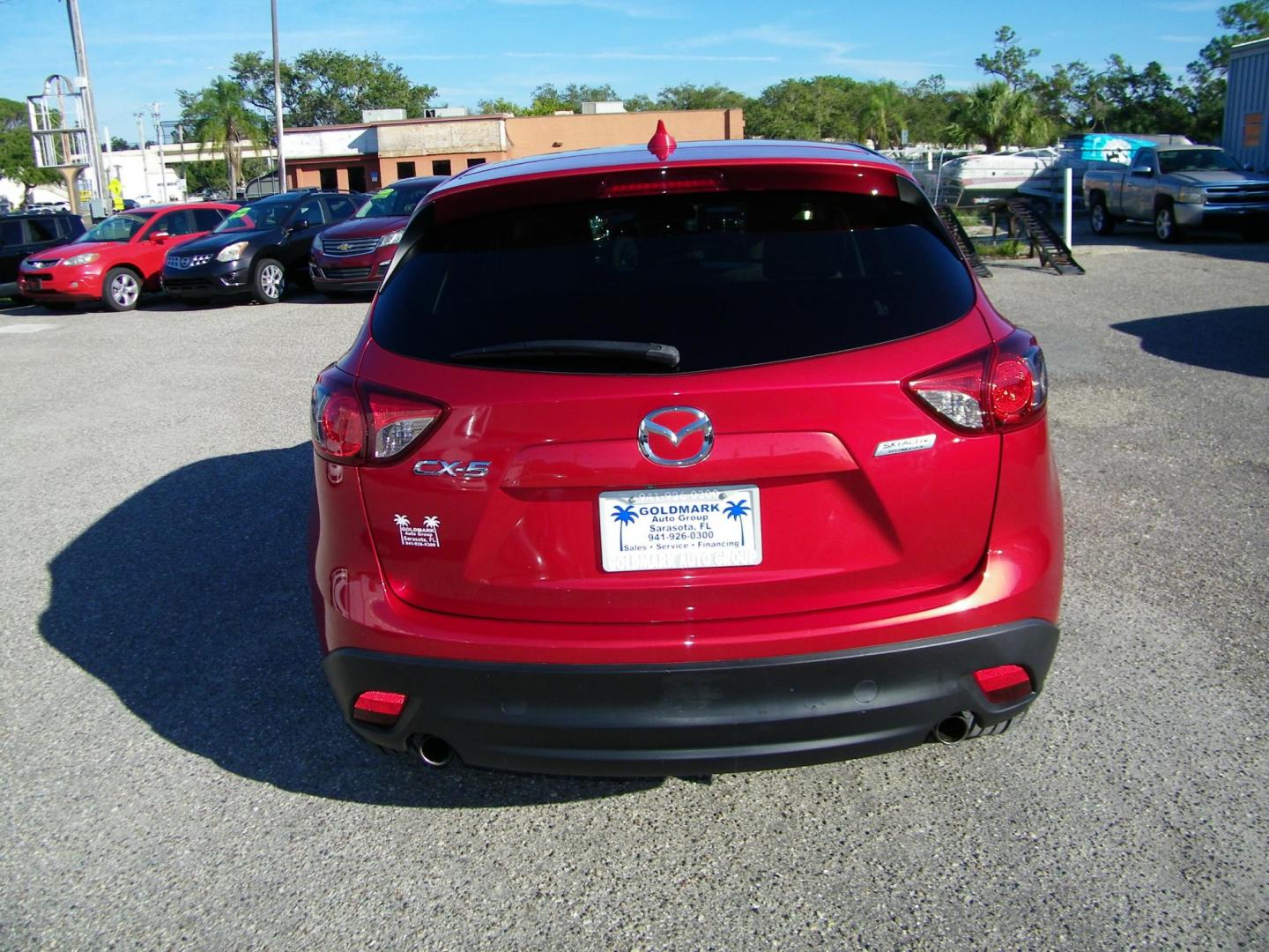 2016 Red /Beige Mazda CX-5 Touring (JM3KE2CY0G0) with an 2.5L L4 DOHC 16V engine, 6-Speed Automatic transmission, located at 4000 Bee Ridge Road, Sarasota, FL, 34233, (941) 926-0300, 27.298664, -82.489151 - Photo#4