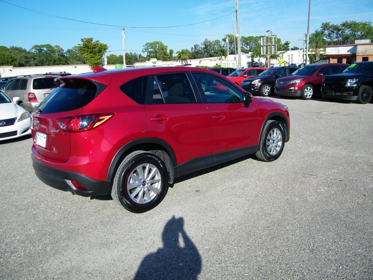 2016 Red /Beige Mazda CX-5 Touring (JM3KE2CY0G0) with an 2.5L L4 DOHC 16V engine, 6-Speed Automatic transmission, located at 4000 Bee Ridge Road, Sarasota, FL, 34233, (941) 926-0300, 27.298664, -82.489151 - Photo#5