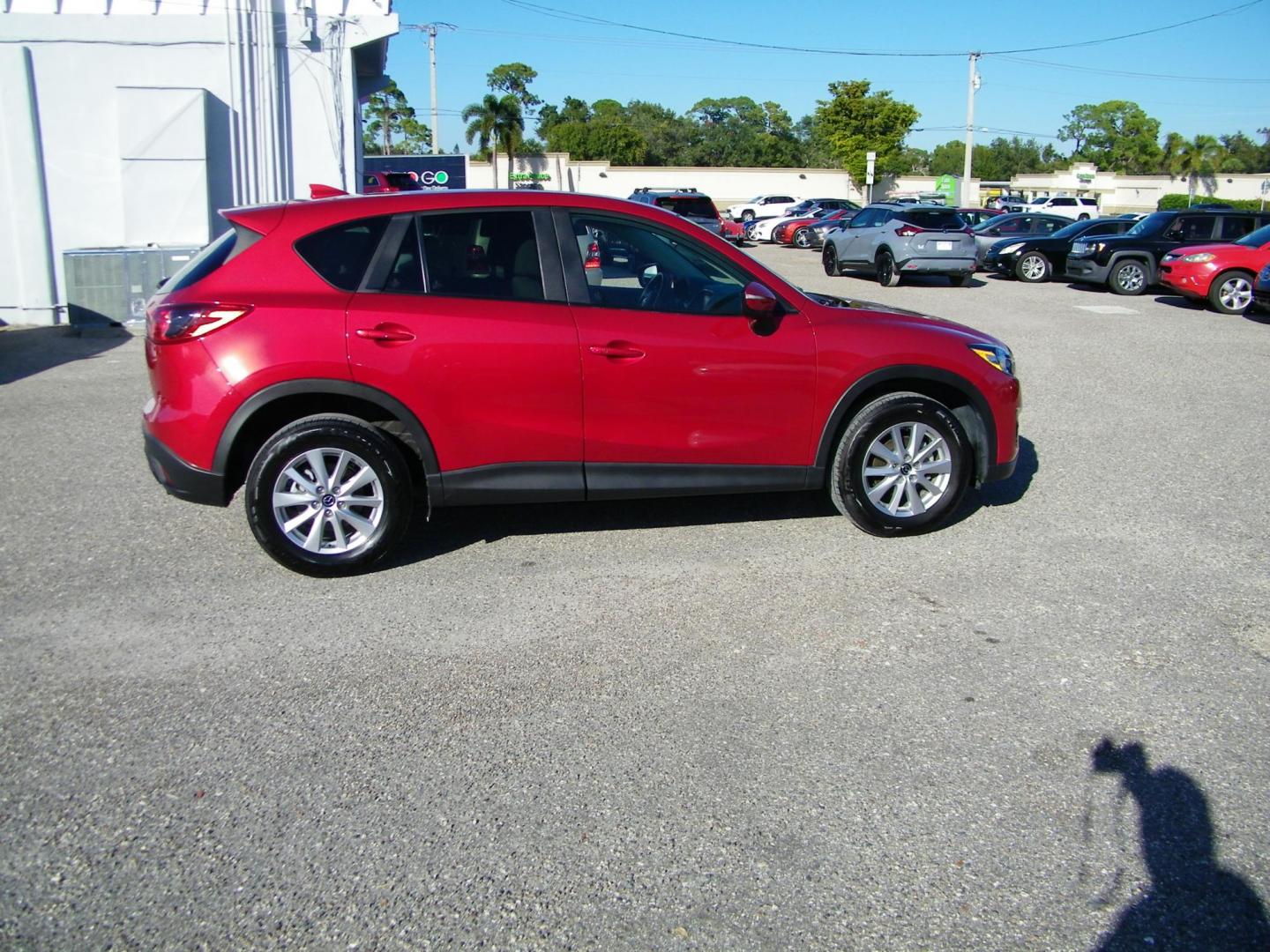 2016 Red /Beige Mazda CX-5 Touring (JM3KE2CY0G0) with an 2.5L L4 DOHC 16V engine, 6-Speed Automatic transmission, located at 4000 Bee Ridge Road, Sarasota, FL, 34233, (941) 926-0300, 27.298664, -82.489151 - Photo#6